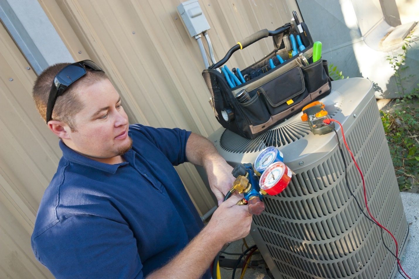 MC Air technician servicing a commercial air conditioning unit